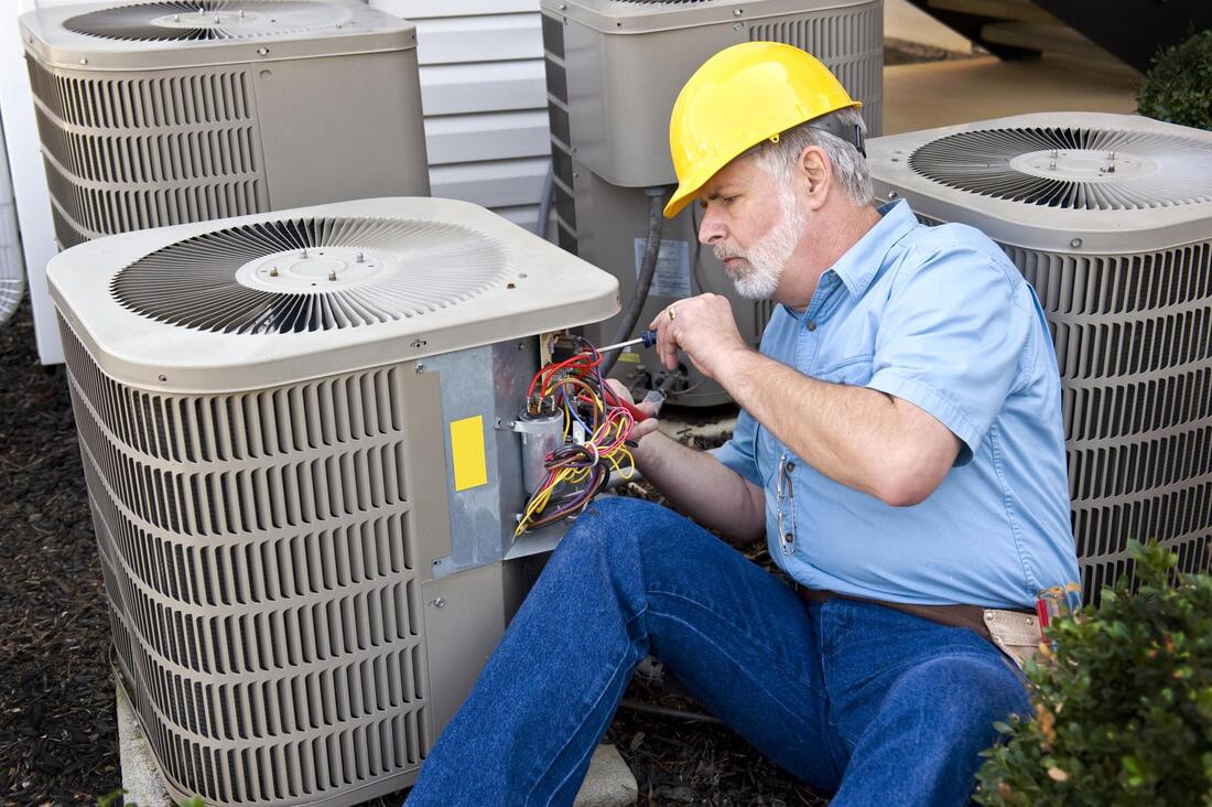 man fixing an ac wire